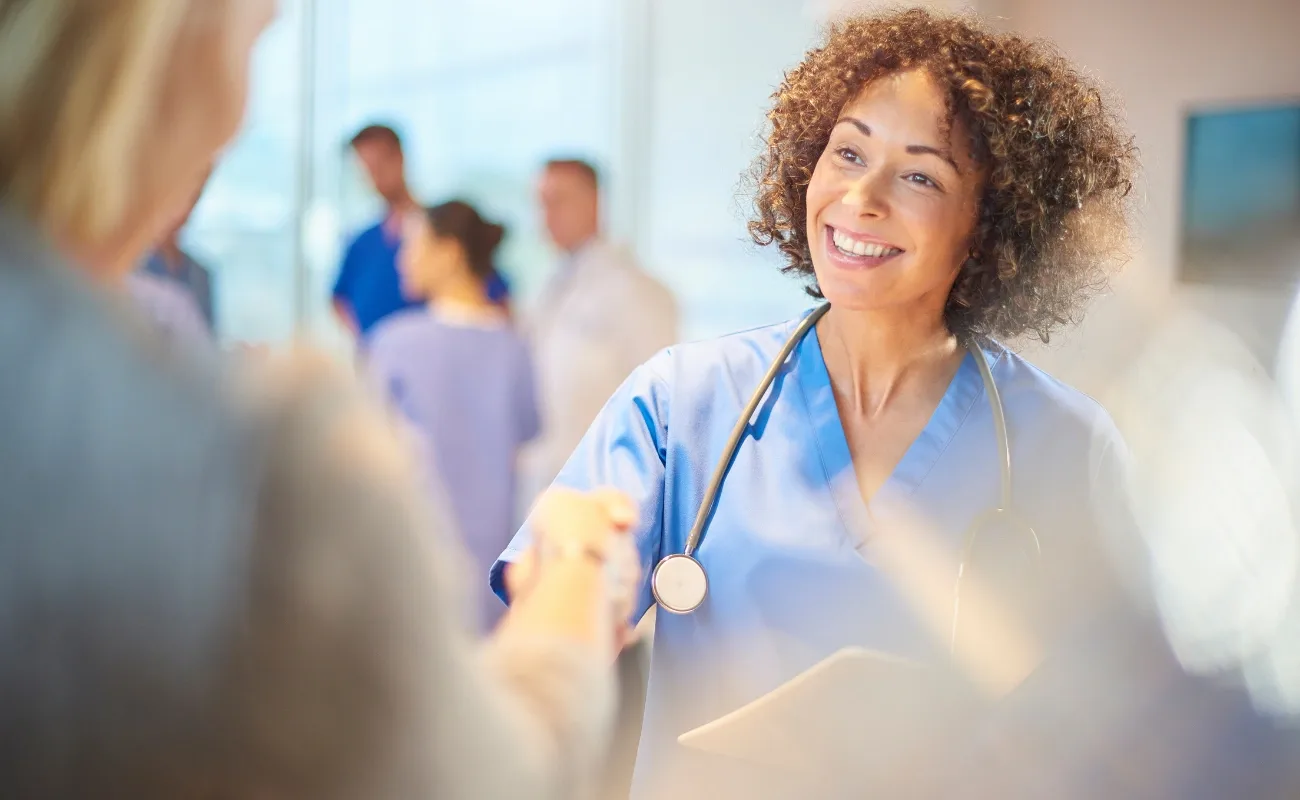 friendly family medicine doctor greeting patient with handshake