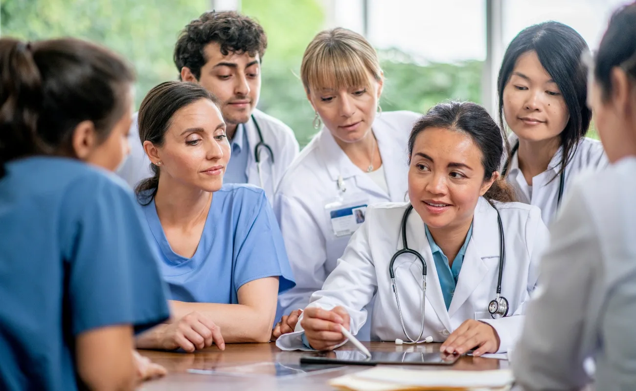 pcmh family medicine team reviewing patient chart on tablet