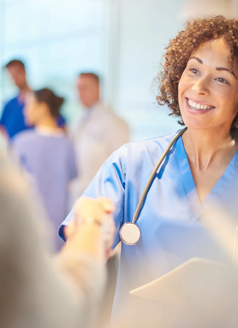 friendly family medicine doctor greeting patient with handshake