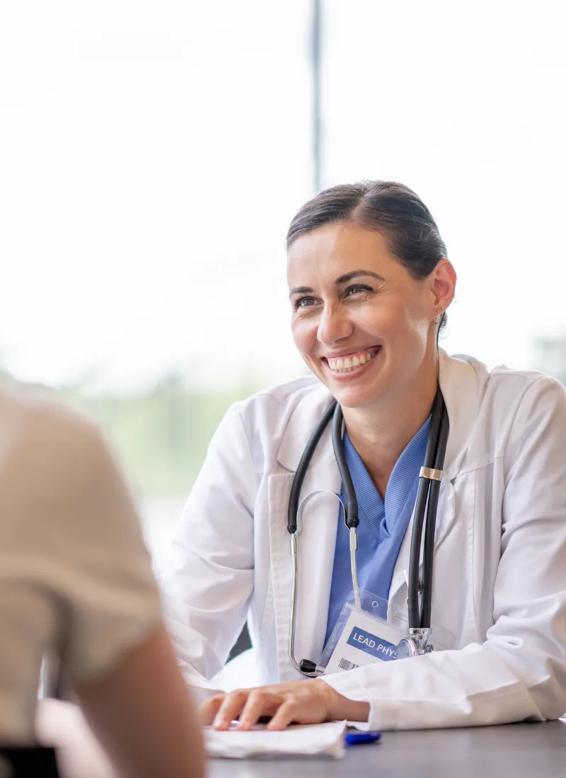 primary care physician smiling during patient consultation