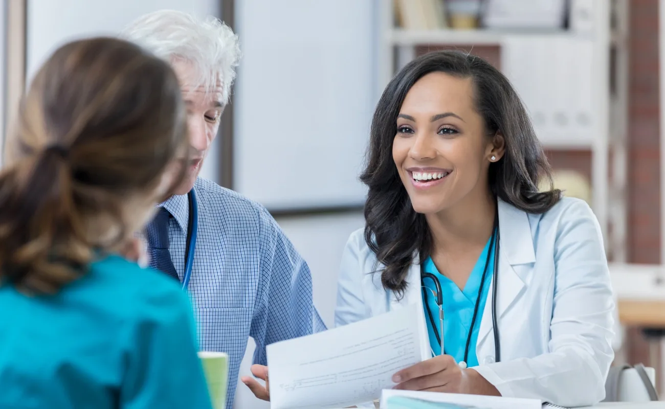 primary care consultation reviewing medical chart with patient