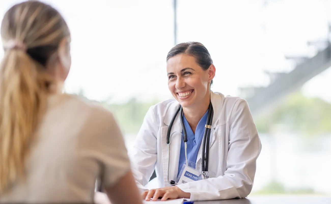 primary care physician smiling during patient consultation